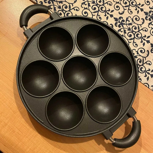 You're describing a multi-functional cast iron pan that can be used for cooking various breakfast items like omelettes and cakes due to its non-stick surface and durability: